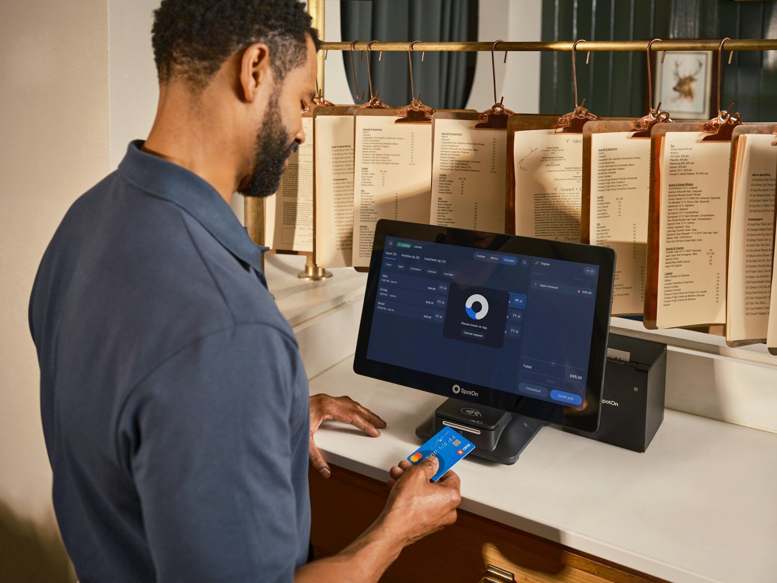 Man paying with credit card at a terminal.